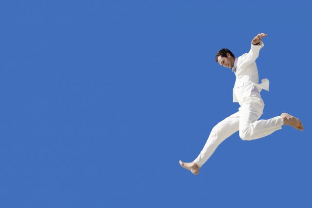 Businessman Leaping in Mid-Air
